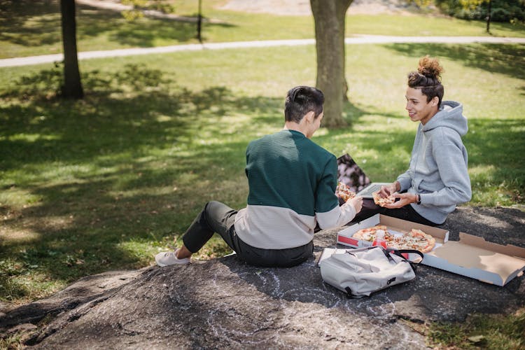 Male Friends Spending Time With Laptop Outdoors