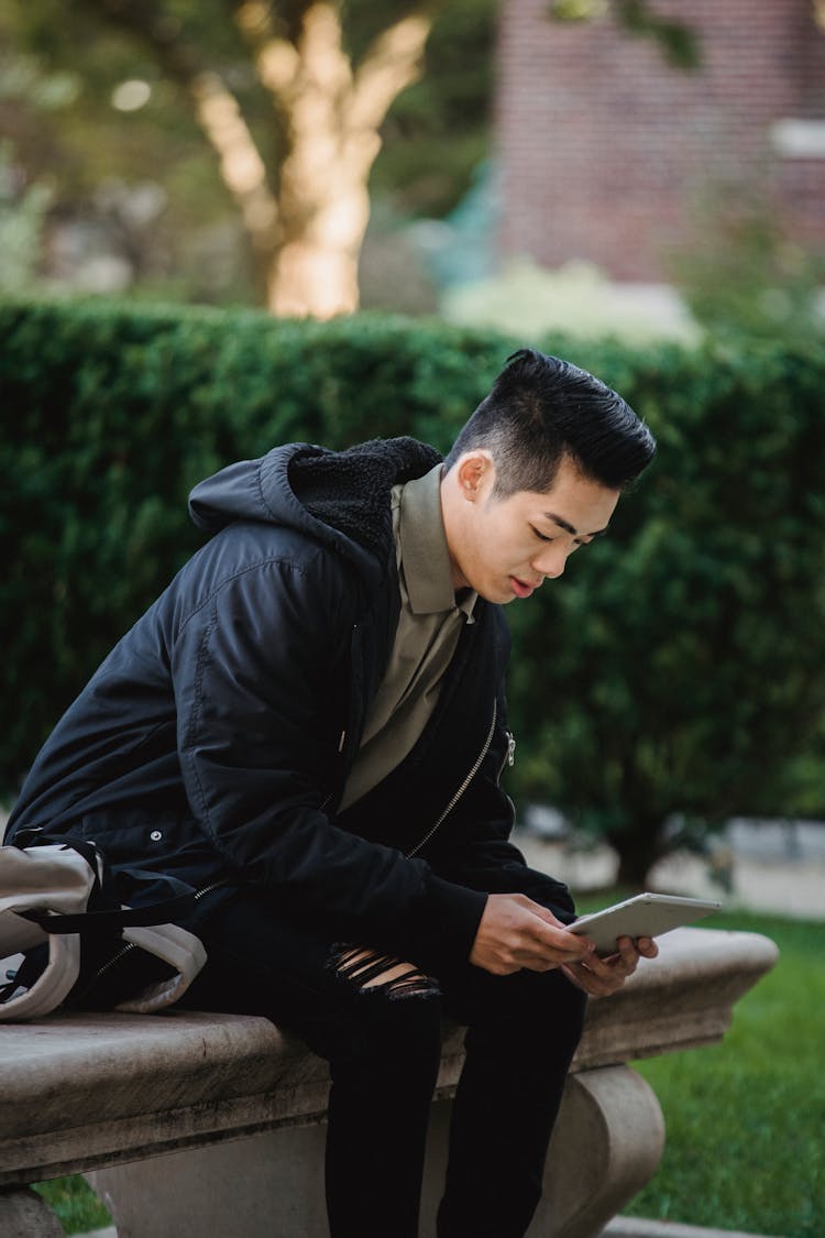 Focused Ethnic Man Using Tablet