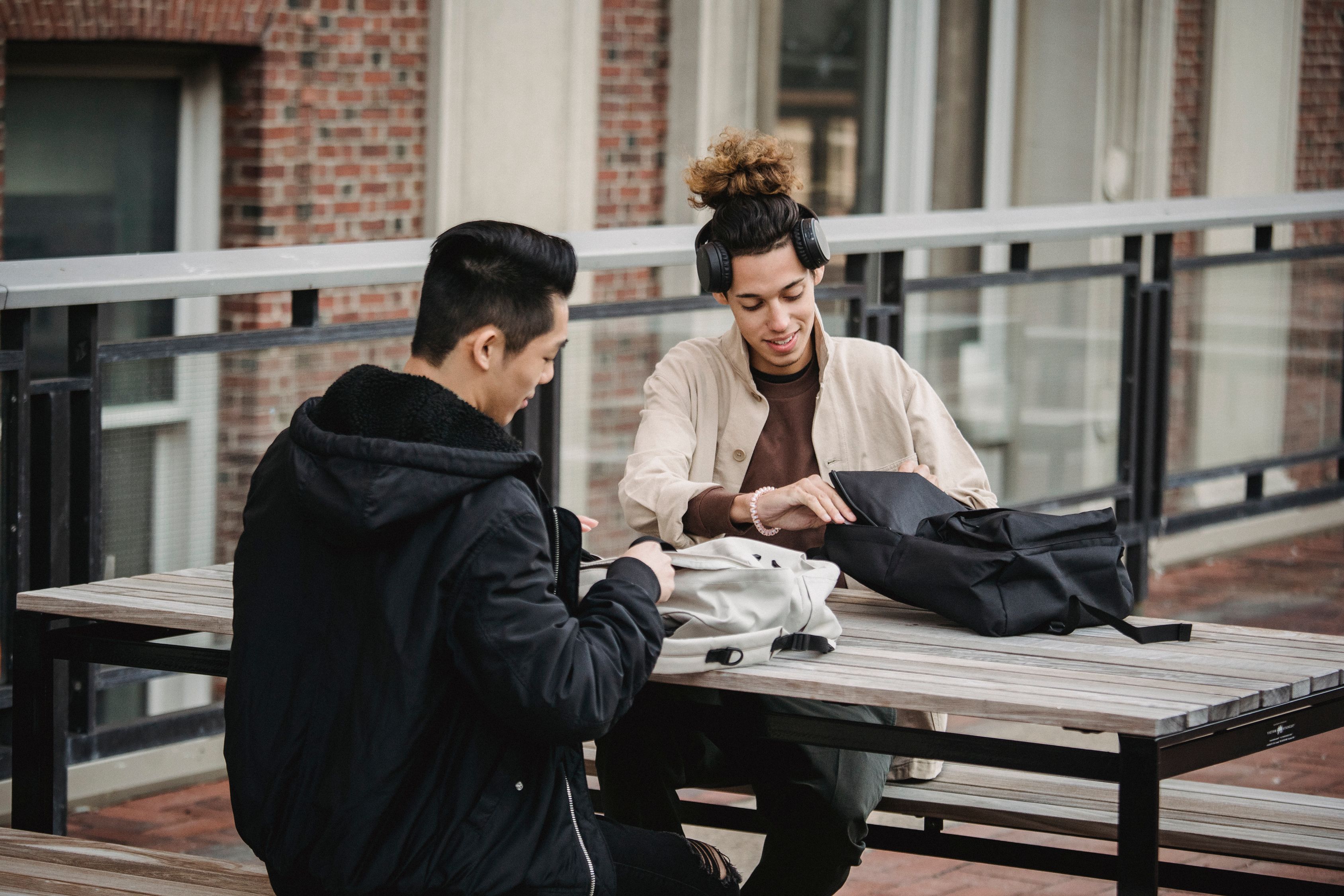 Young Men Taking Out Stuff From Backpacks Free Stock Photo young-men-taking-out-stuff-from-backpacks-free-stock-photo