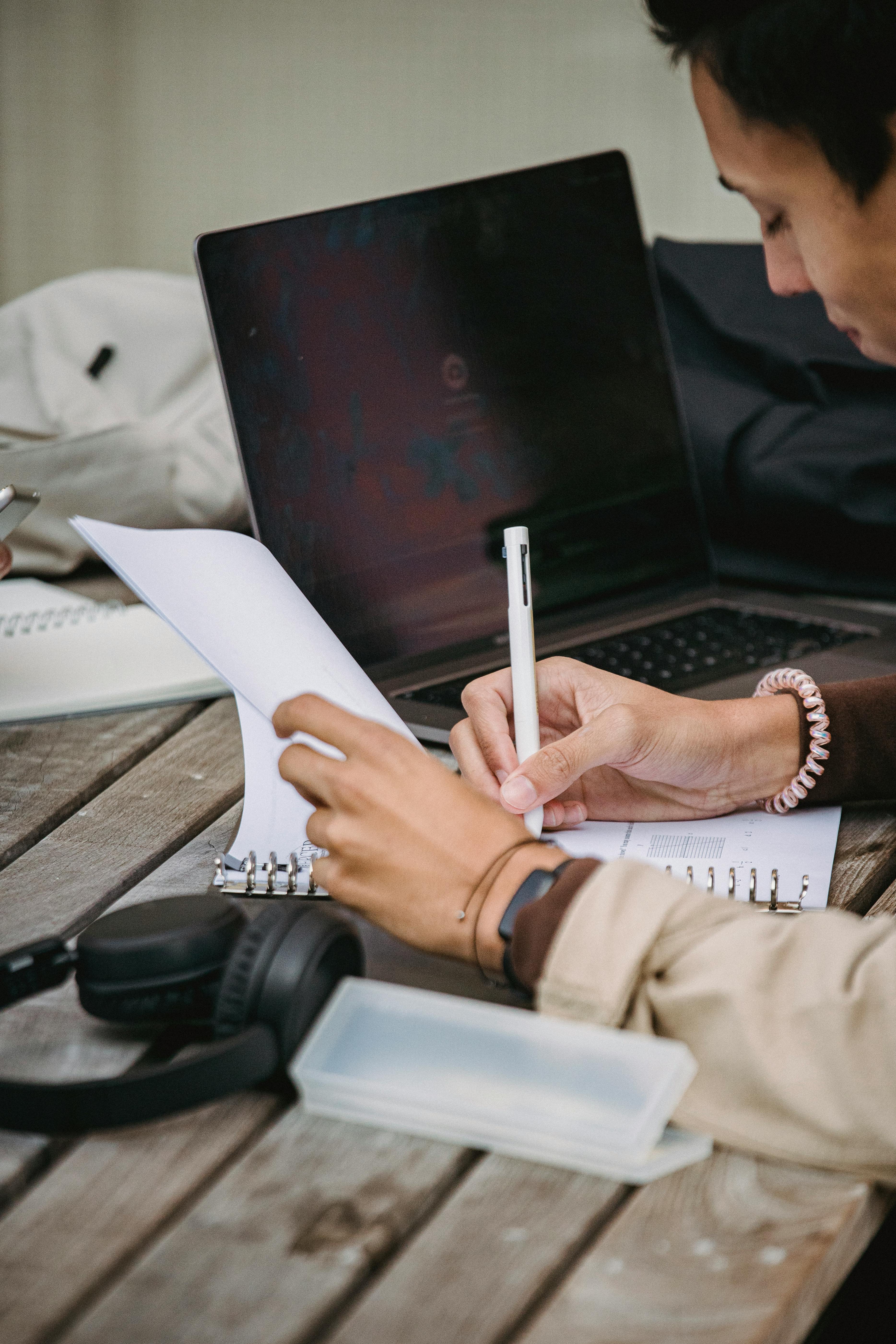 Person Writing On A Notebook · Free Stock Photo