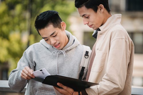 Young multiethnic partners reading documents