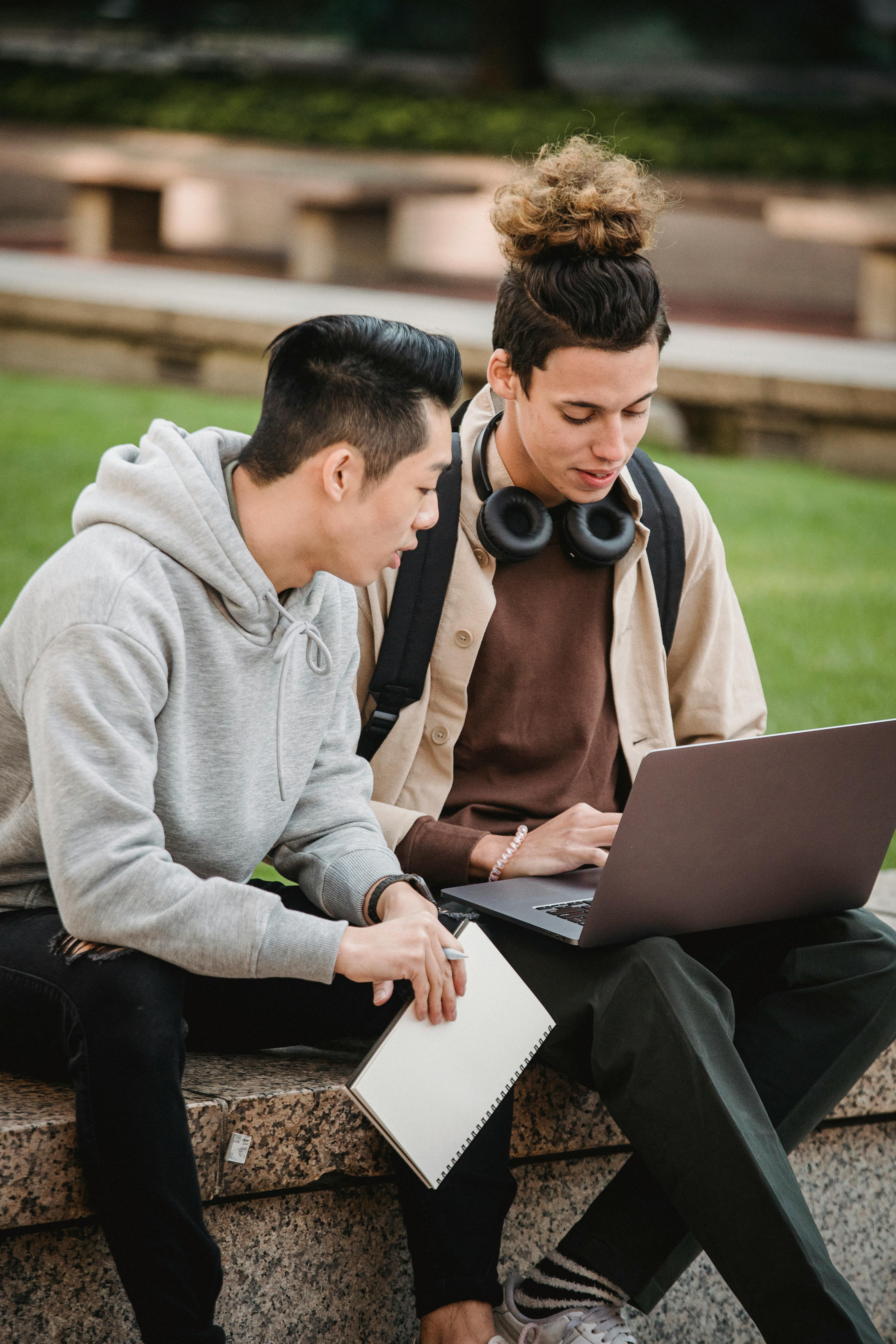 young multiethnic students using laptop