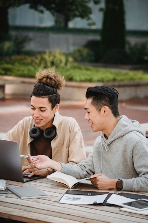 Cheerful diverse students working on project