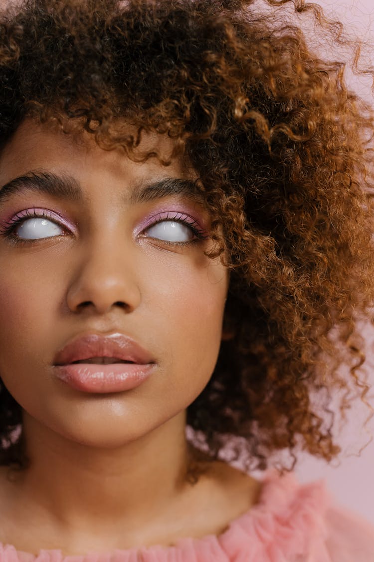 A Woman Curly Hair And White Eyes