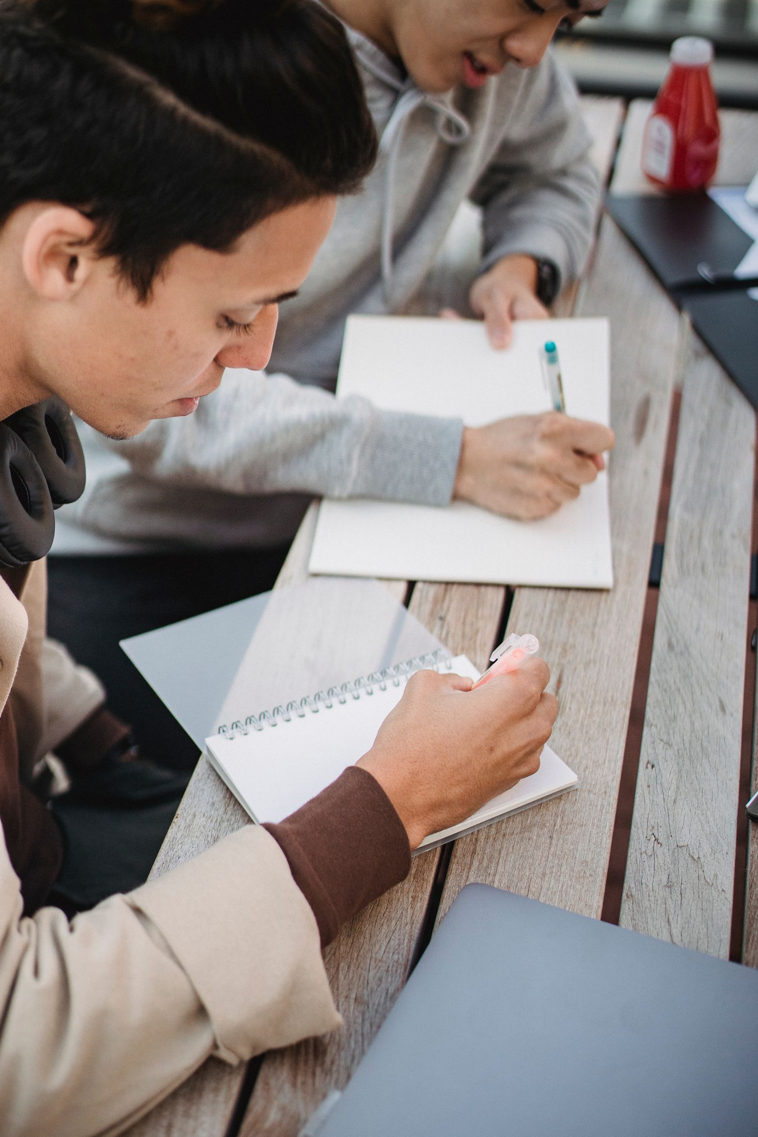 Focused Students Taking Notes At Table Free Stock Photo Focused students taking notes at table free stock photo