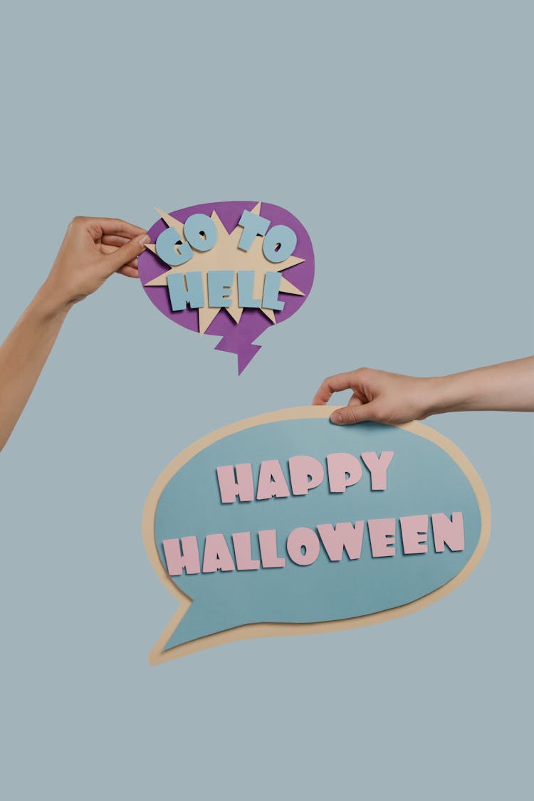 People Holding Halloween Theme Paper Cutouts