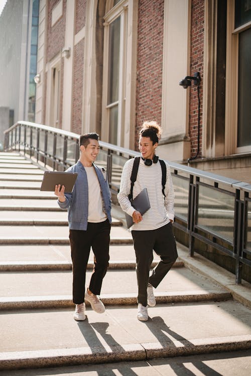 Multiethnic students walking along stairway in campus