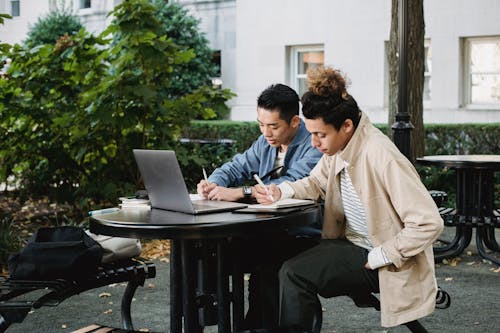 Diligent multiethnic students doing homework together