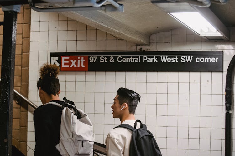 Asian Man Walking With Friend In Underground