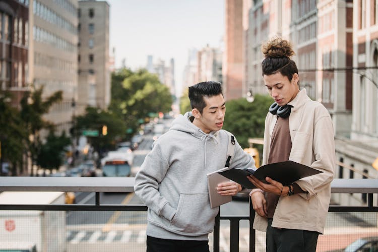 Diverse Smart Students Reading Report On Bridge Of Asphalt Road