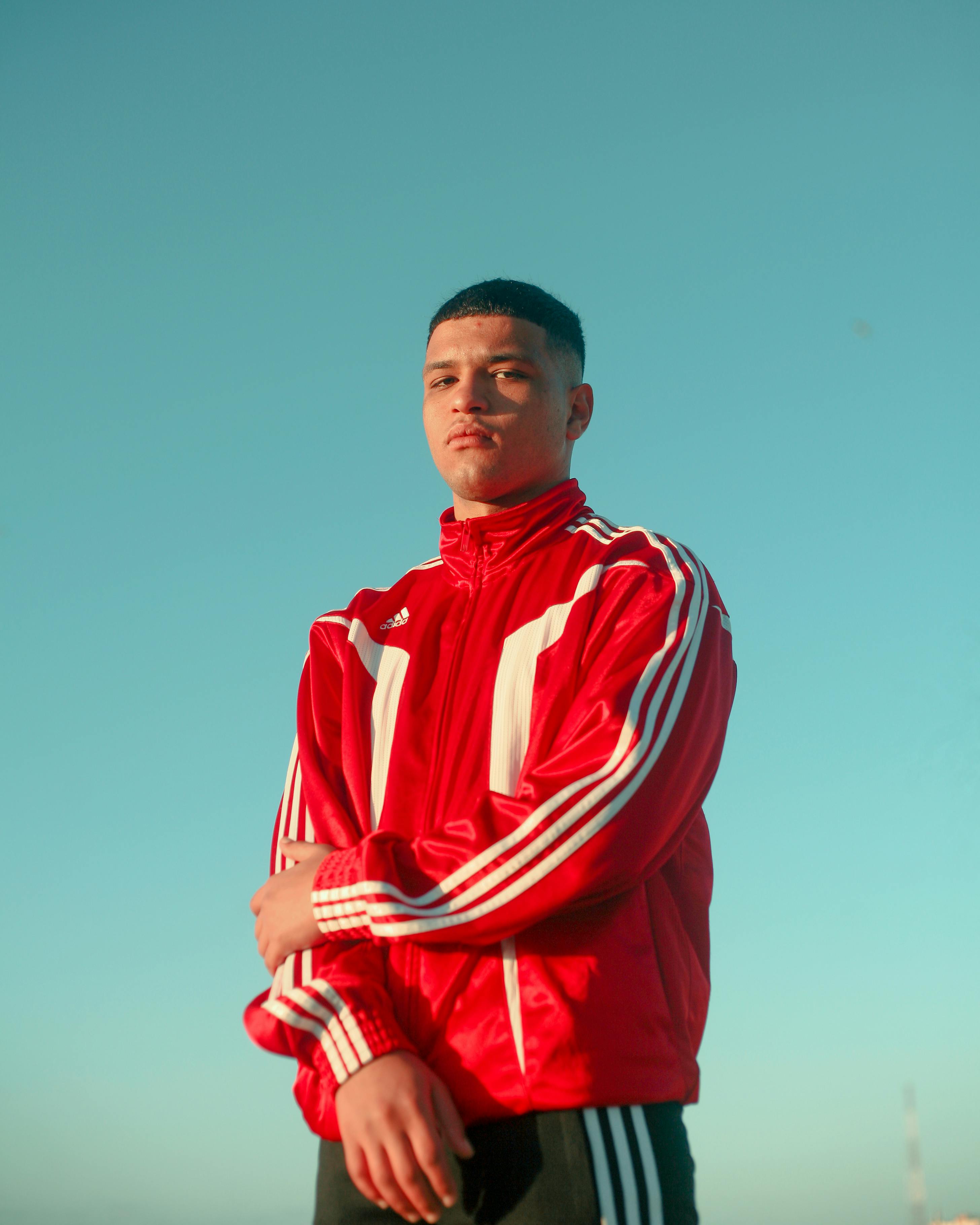 man in red and white adidas red jacket