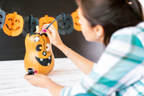 Free A Woman Painting Halloween Decoration Stock Photo