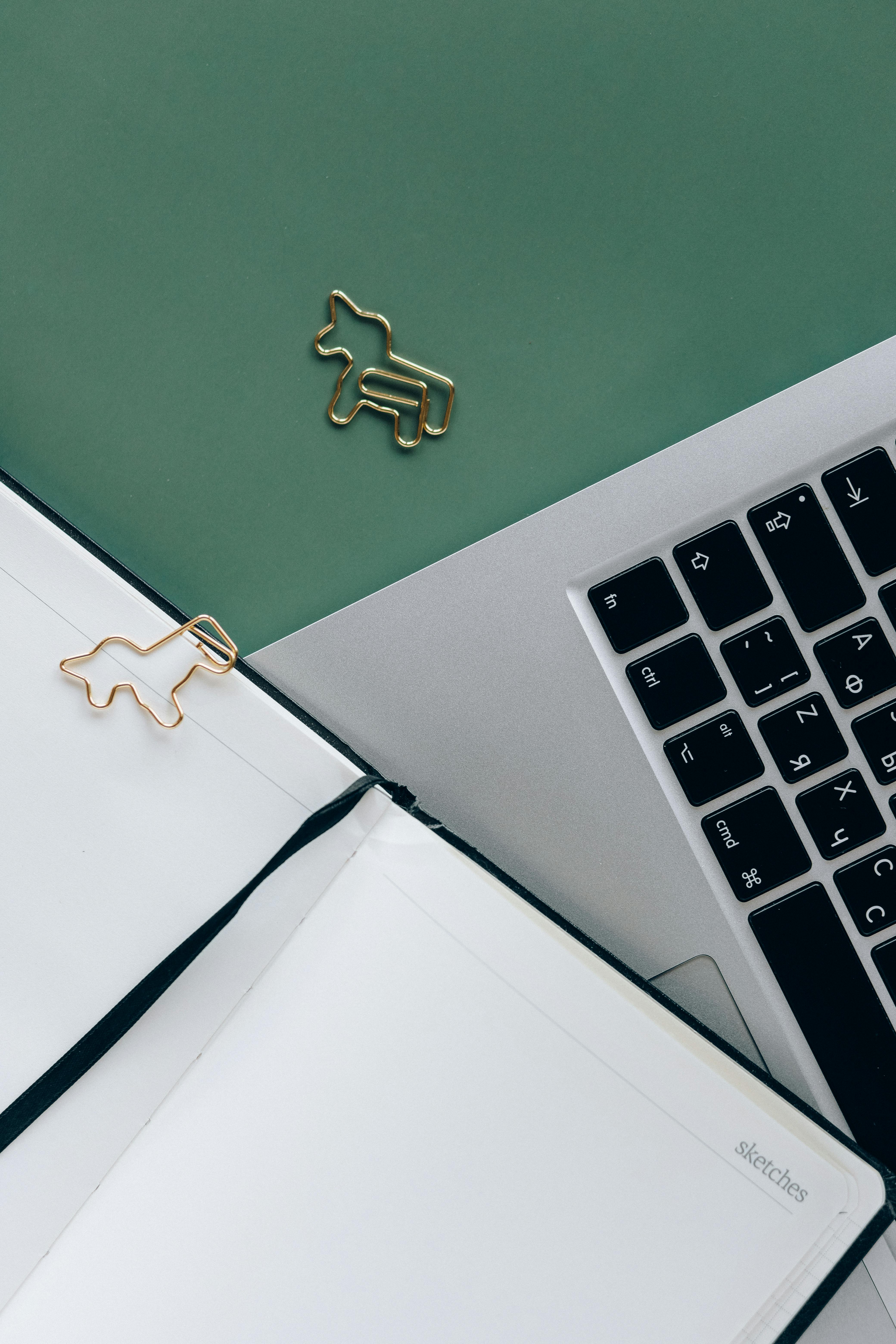 animal shaped paper clips on green surface