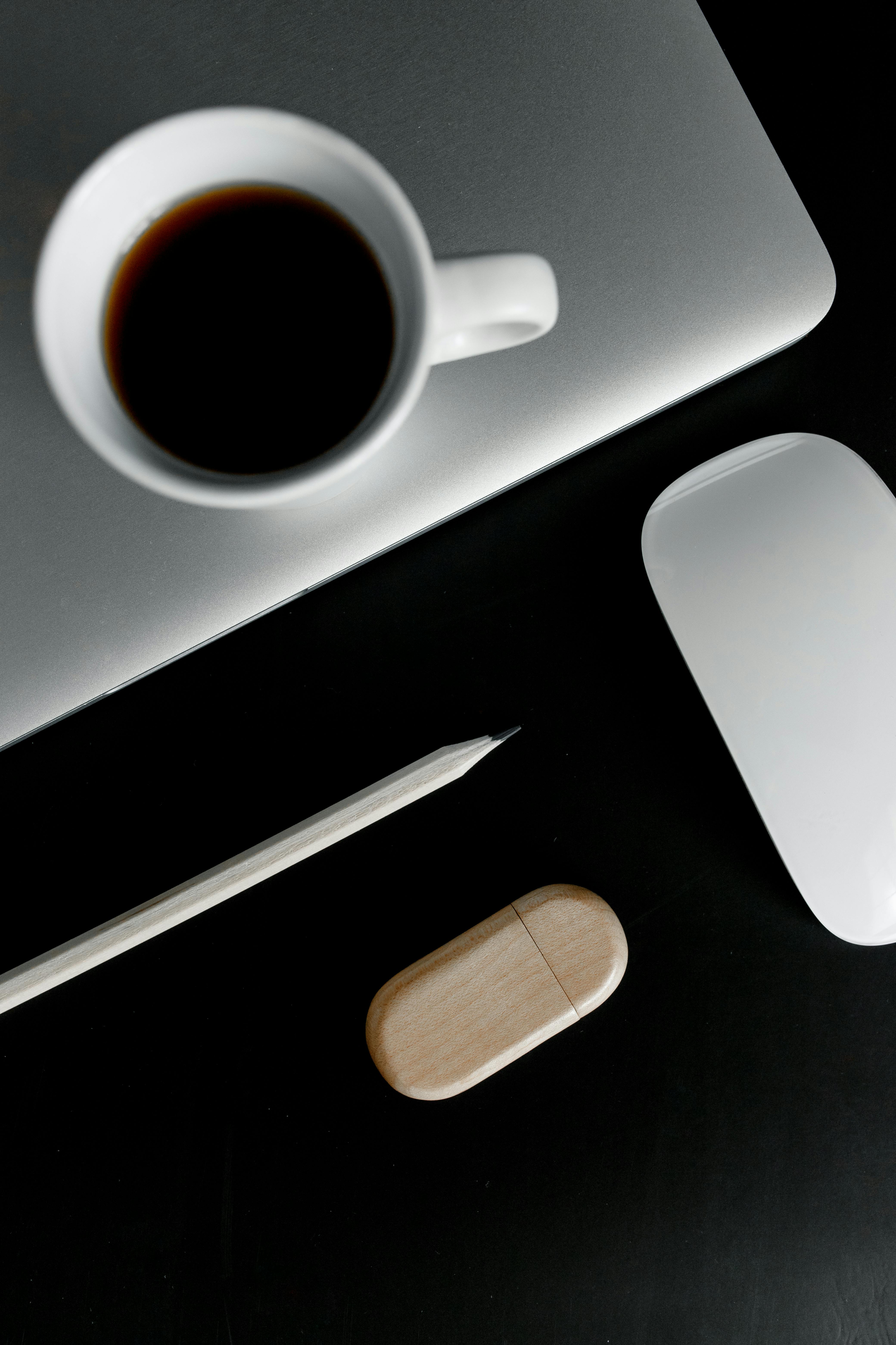 cup of coffee beside a wooden pencil