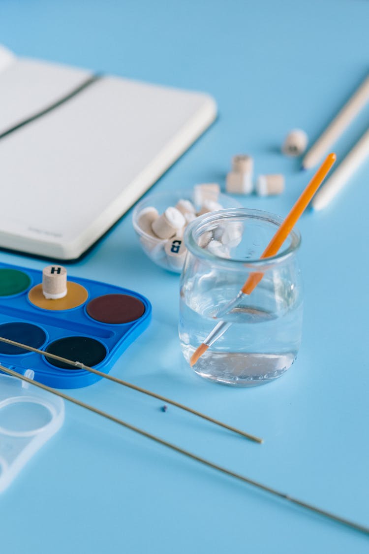 Paint Brush Inside The Glass Jar With Water 