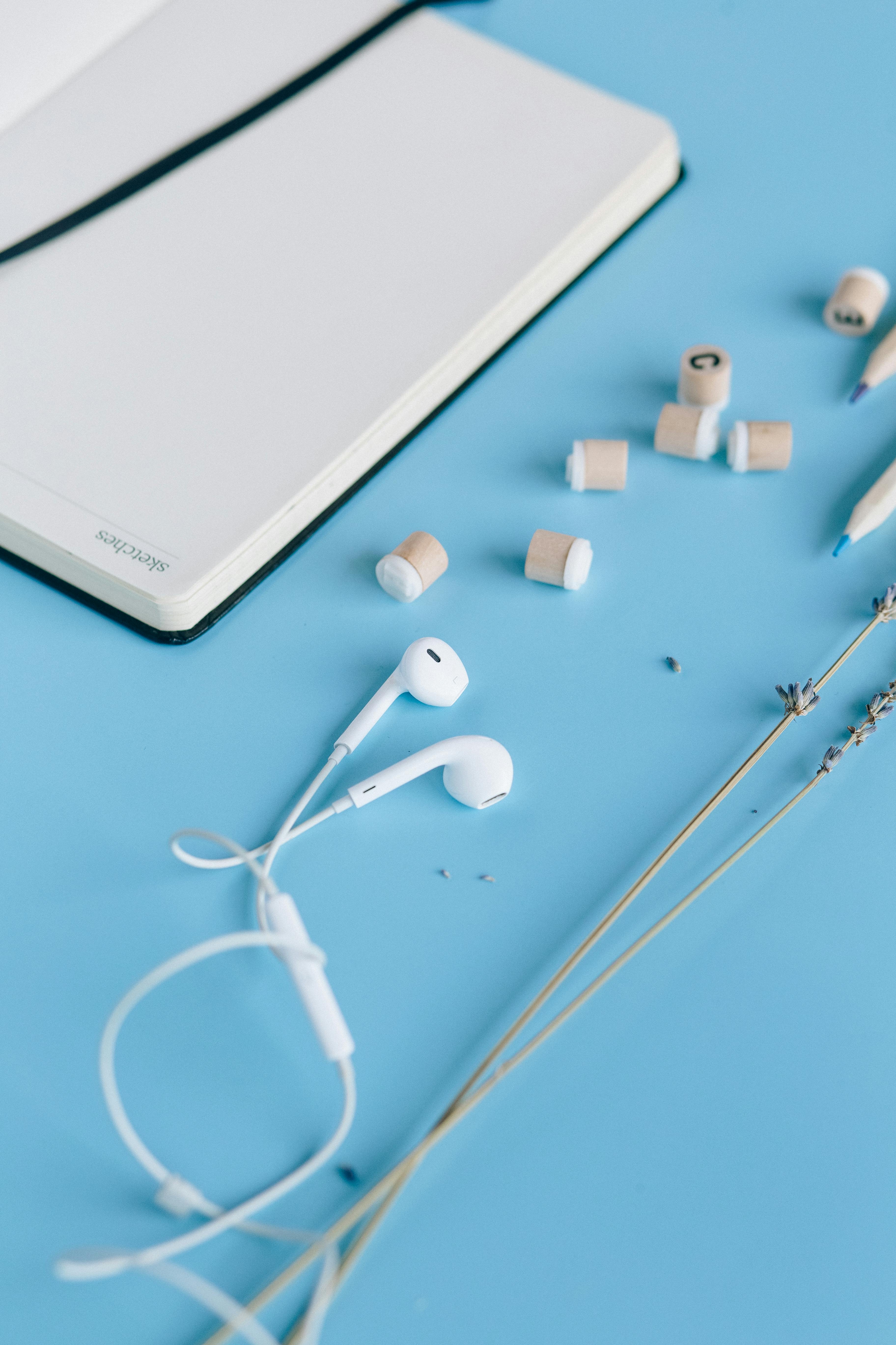 white samsung tablet with white earbuds