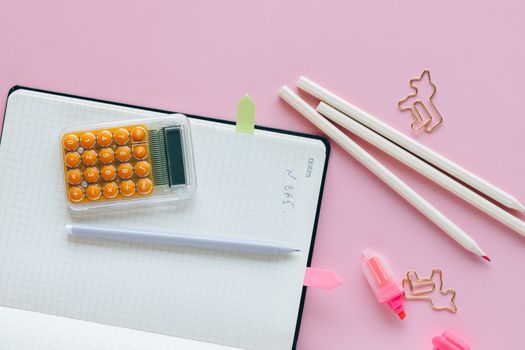 Black and White Calculator Beside Pink Pen