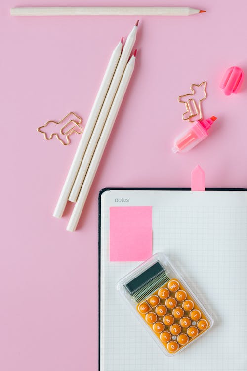 Office Supplies on Pink Surface