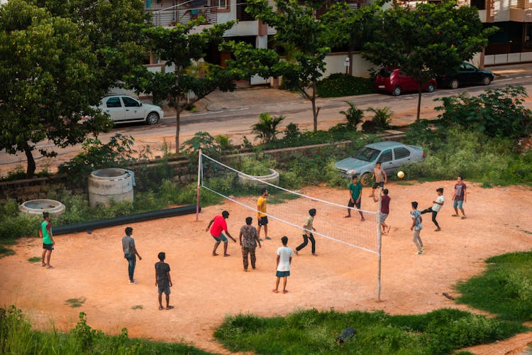 A Group Of People Playing Volleyball 