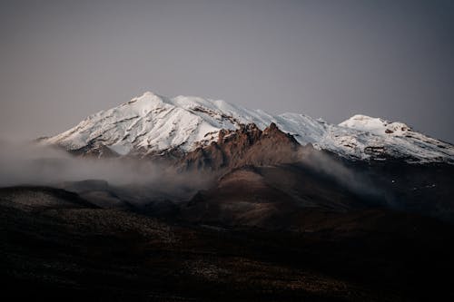 Ücretsiz Gri Gökyüzü Altında Karla Kaplı Dağ Stok Fotoğraflar