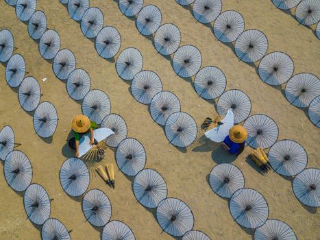 People Making Traditional Umbrellas on the Ground