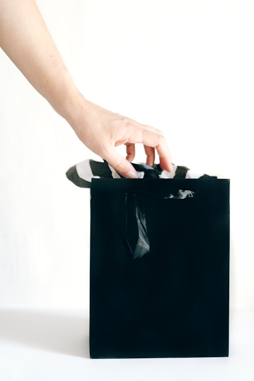 Free Hand Holding a Shopping Bag Stock Photo