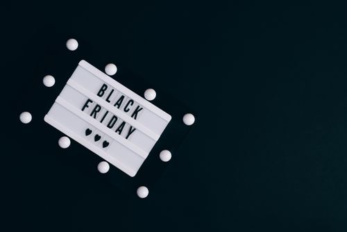 Free Black Friday sign on dark background with hearts for seasonal promotions. Stock Photo