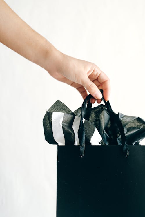 Hand Holding a Shopping Bag