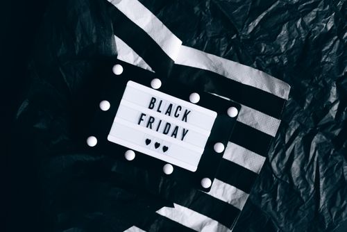 Free Minimalist Black Friday lightbox sign set against a stylish black and white background. Stock Photo