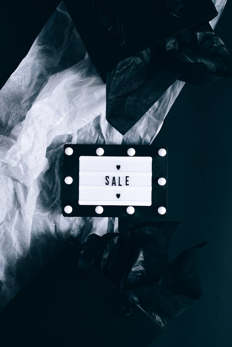 Sale Sign And Black Shopping Bags