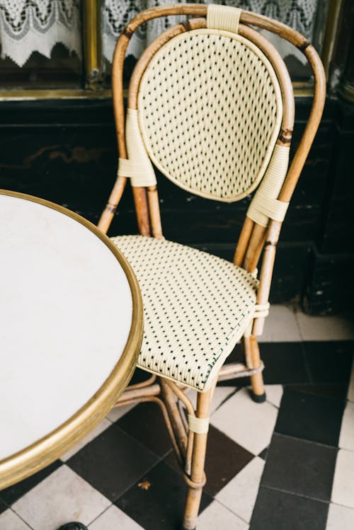 Woven Chair with Wooden Frame Beside a Round Table