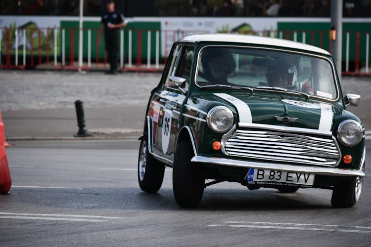 Man In Helmet Driving On Vintage Car