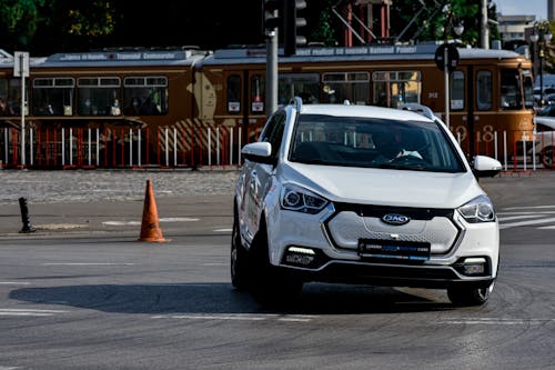 Hatchback white car driving on asphalt road