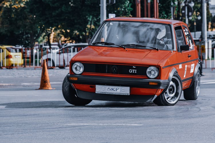 Old Sports Car Driving On Street