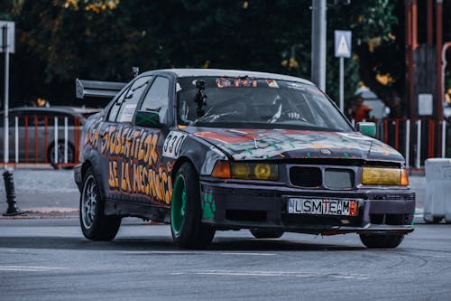 Unrecognizable person in helmet riding sport car