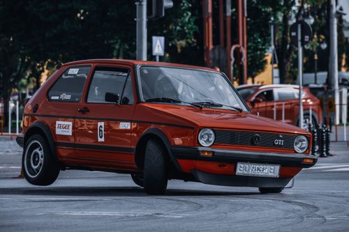 Free Unrecognizable person in helmet driving fast during race on asphalt track in city Stock Photo