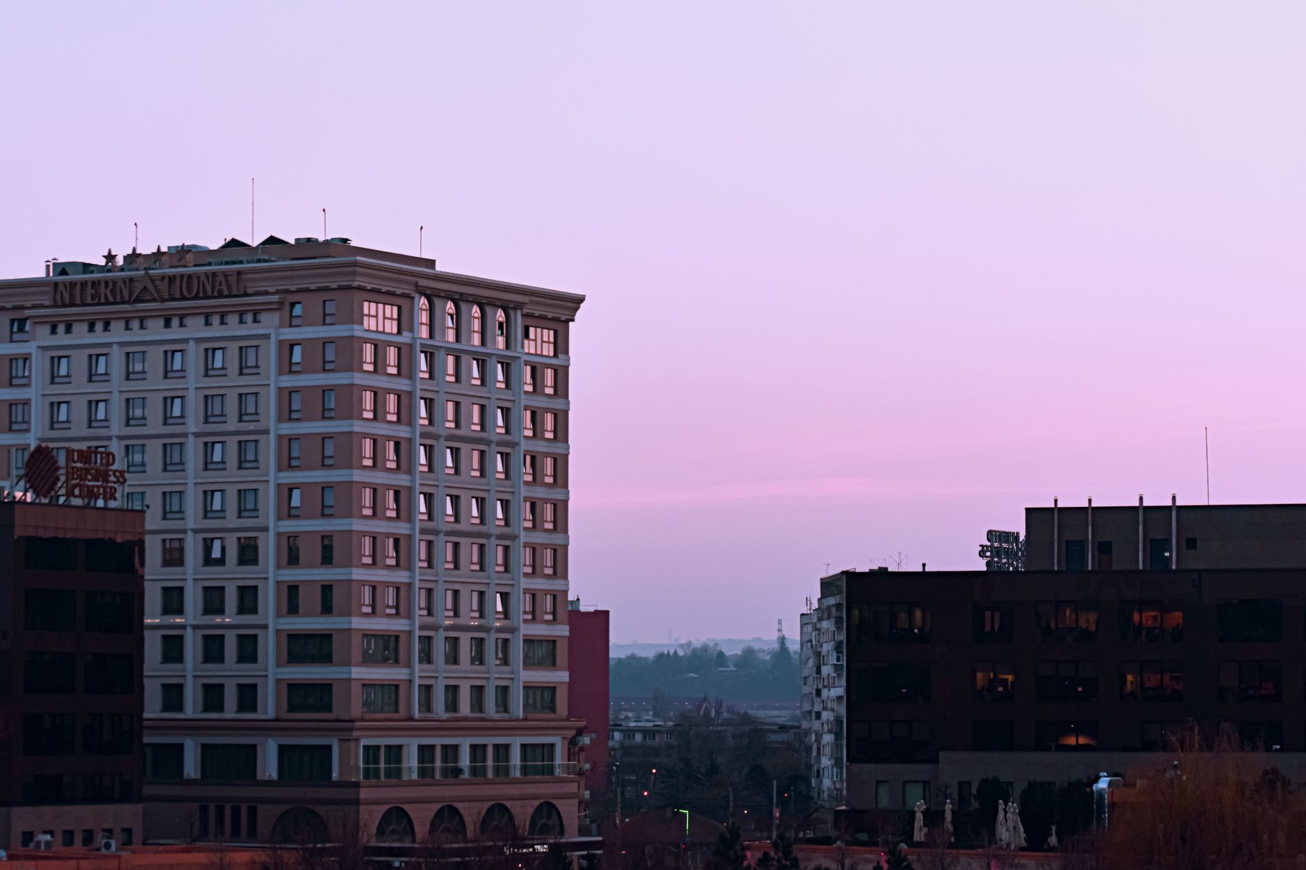 Modern international four star hotel complex surrounded by business centers at colorful sunset in downtown of megapolis Related image for Market Trends: Trends Shaping Hotels in 2026.