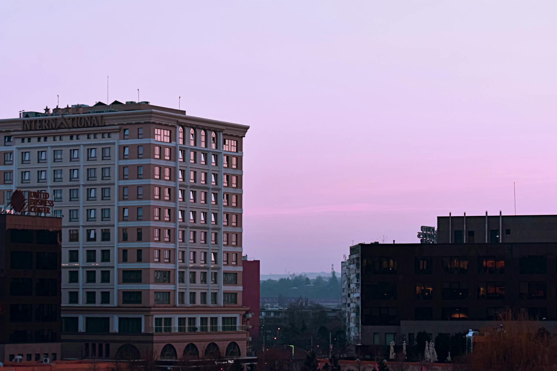 Cityscape with modern international hotel on sunset