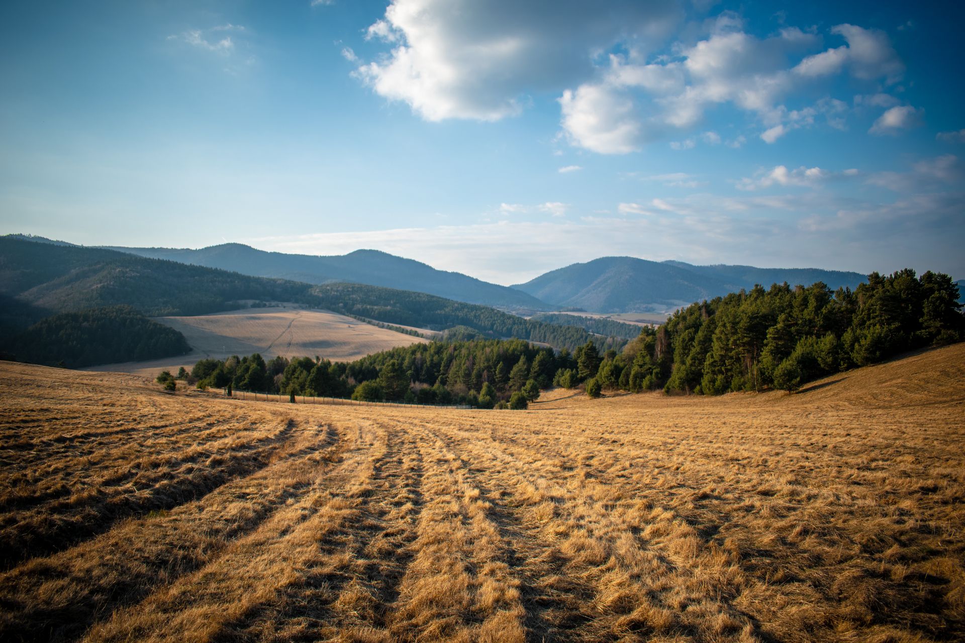 Beautiful rural landscape in Víťaz, Slovakia with mountains and clear blue sky.