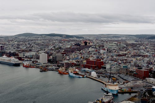 Boats and ships moored in port of coastal city