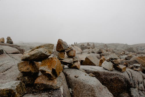 Rough stones on boulders under foggy sky