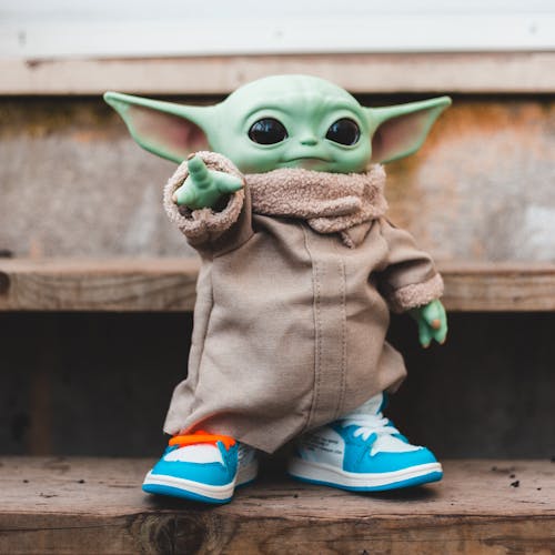 Toy figure in modern sneakers on stairs