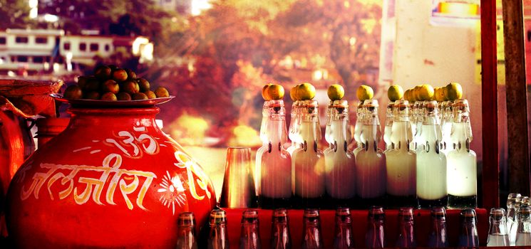 Glass Bottles Beside Red Ceramic Container