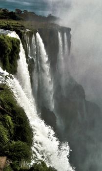 Majestic view of Iguazu Falls cascading in lush Misiones Province, Argentina.