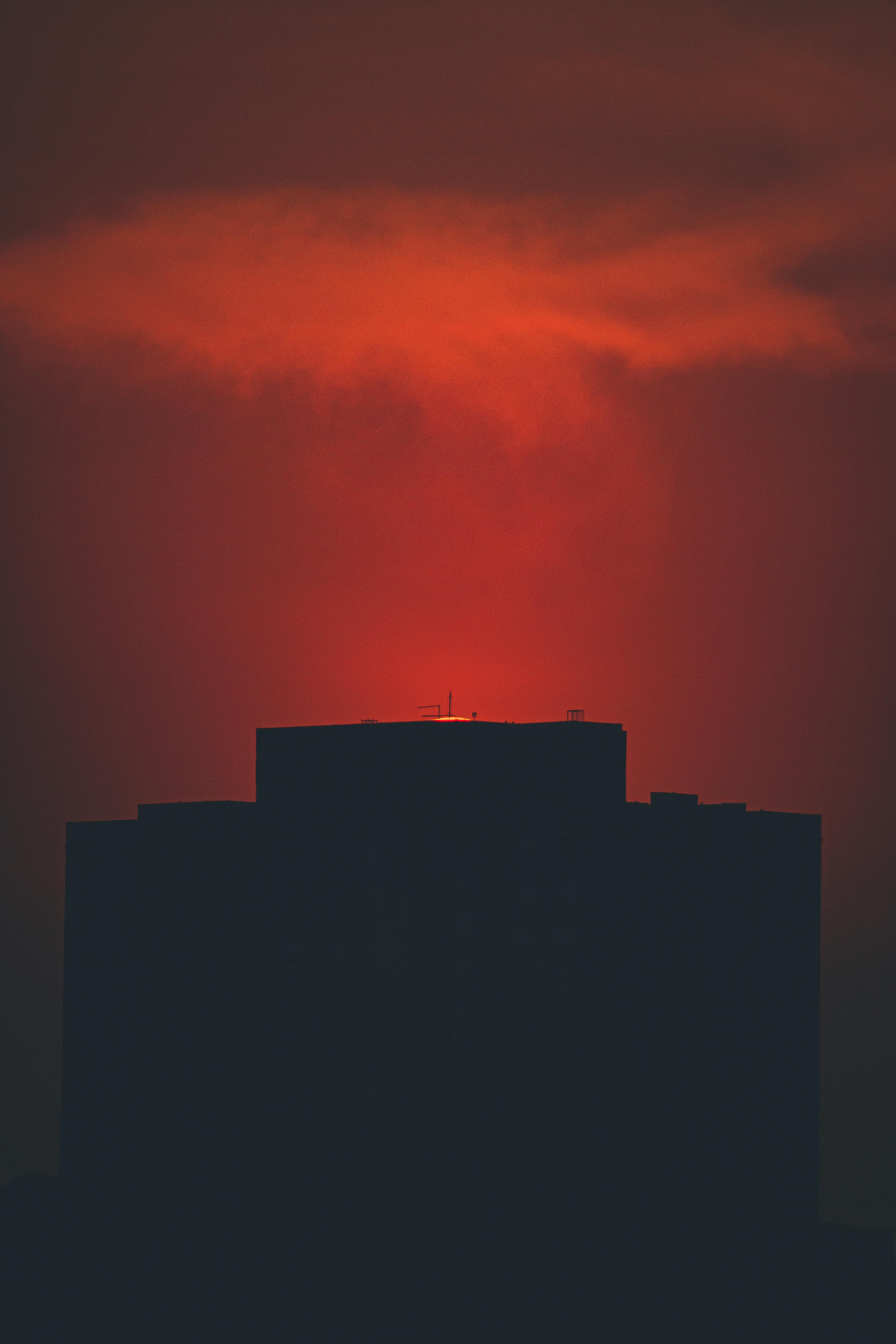 colorful sunset above building at night