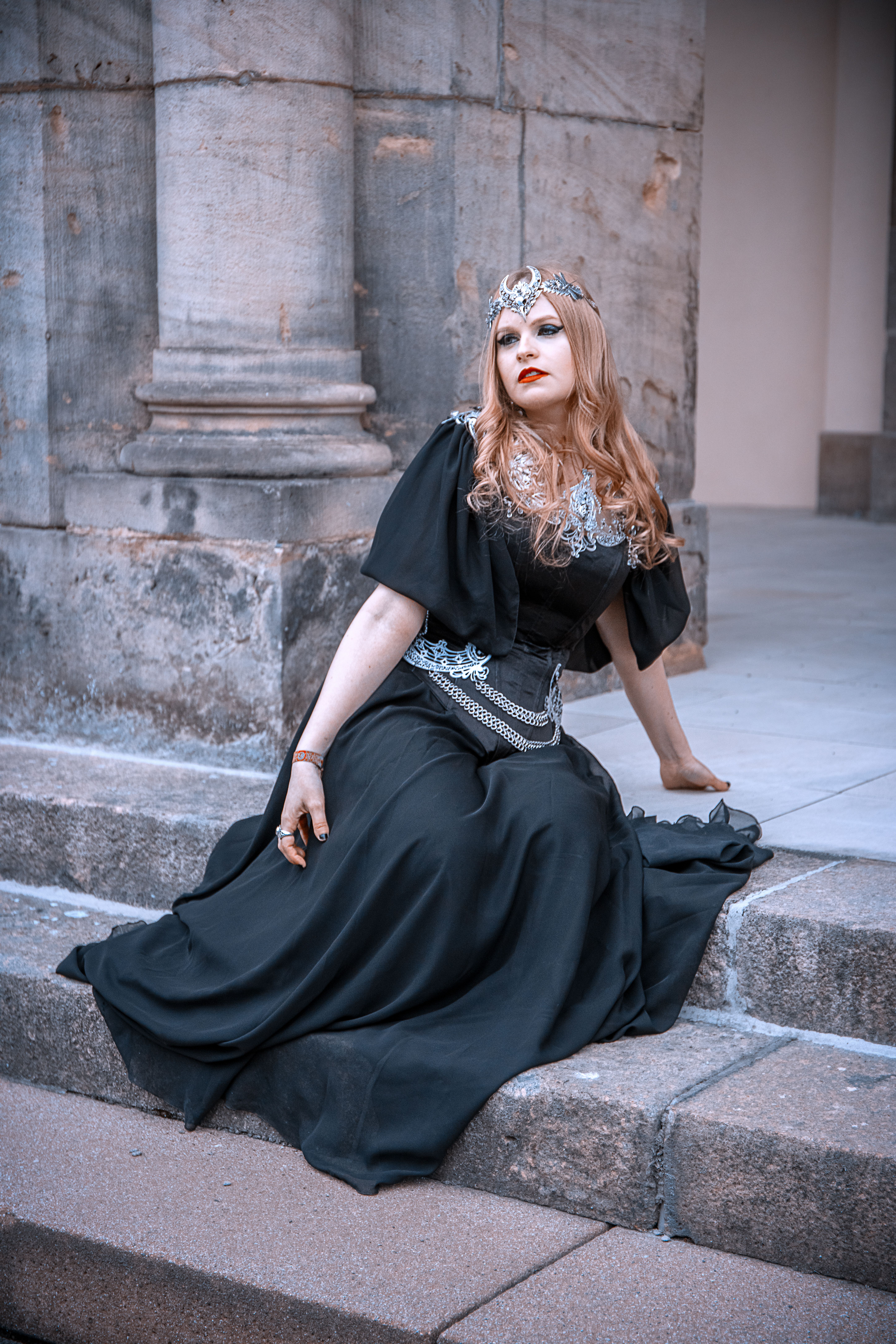 Woman in a Black Dress Sitting on a Concrete Step · Free Stock Photo