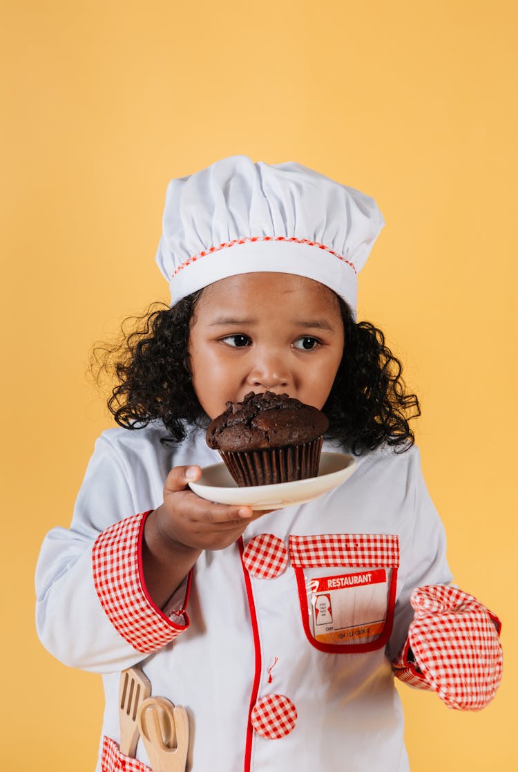 Photo Of Child Eating Chocolate Muffin