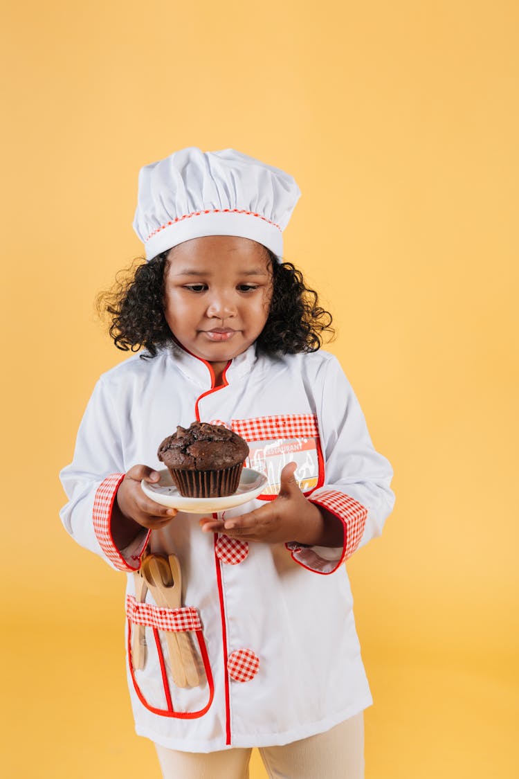 Adorable Black Little Girl With Homemade Cupcake