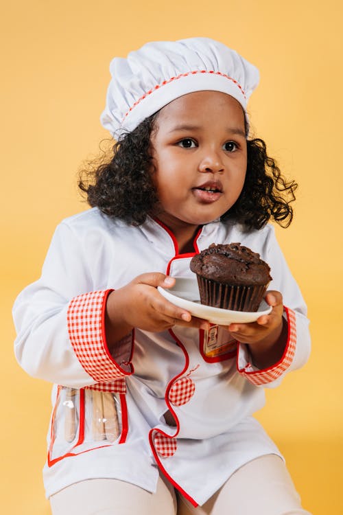 Adorable black girl with chocolate cake