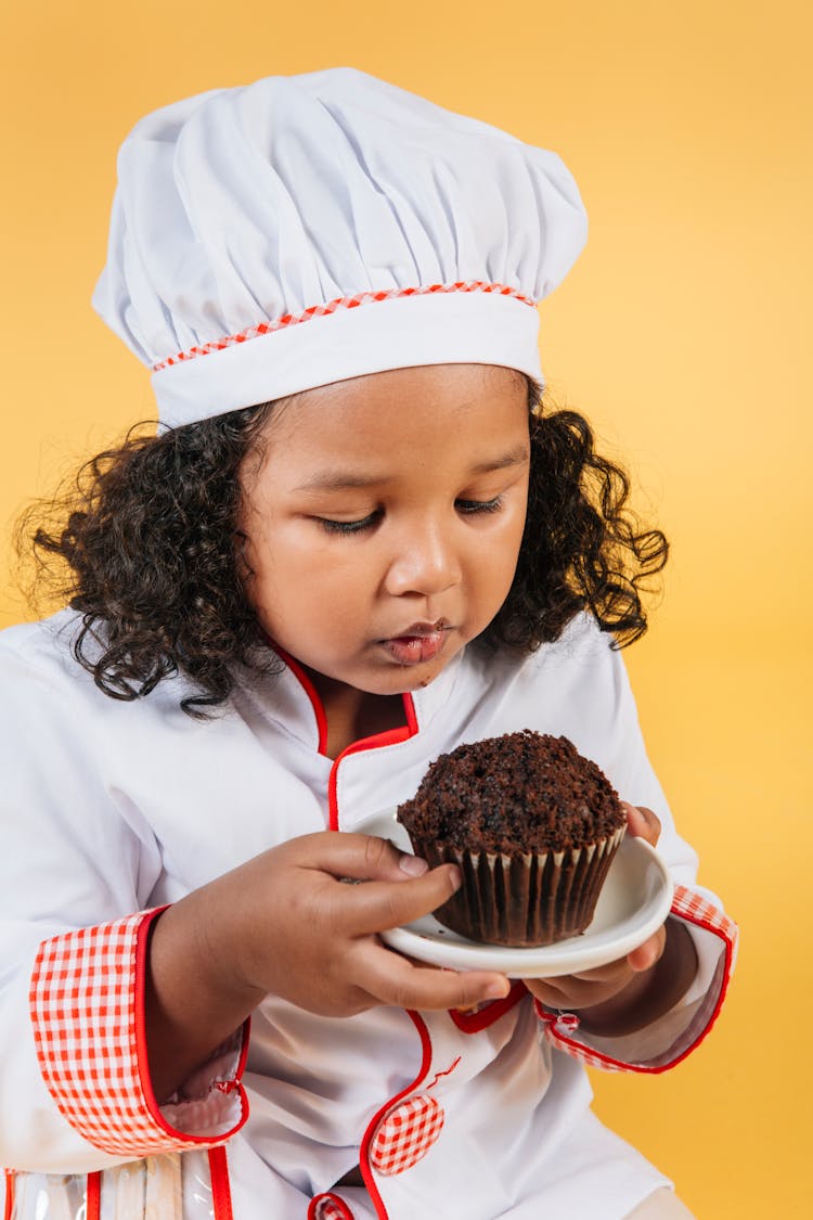 Little Black Girl In Chef Uniform With Chocolate Muffin